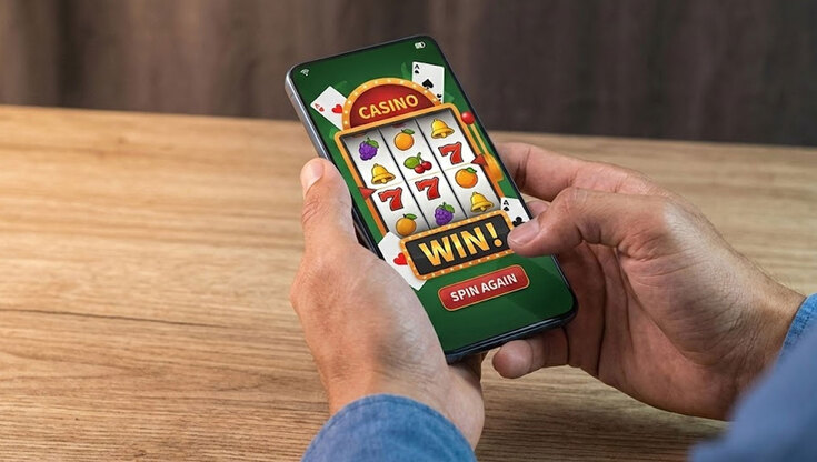 A person playing a slot game on a mobile phone with a winning result